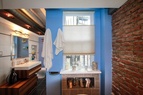 Master Bathroom Loft Airy recessed storage niche exposed brick light blue freestanding soaking tub