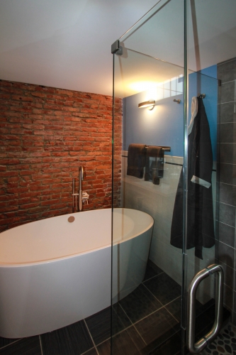 Master Bathroom Soaking Tub exposed brick freestanding tub frameless glass shower
