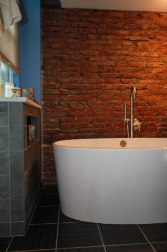 Master dark floor Bathroom Builtin Shelving recessed niche freestanding soaking tub exposed brick