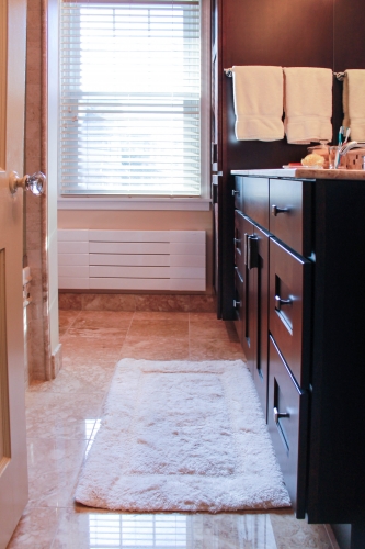 compact bathroom walkin shower wood vanity full height linen closet chrome finishes stone natural storage light floor