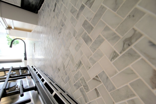 kitchen marble herringbone backsplash gas range