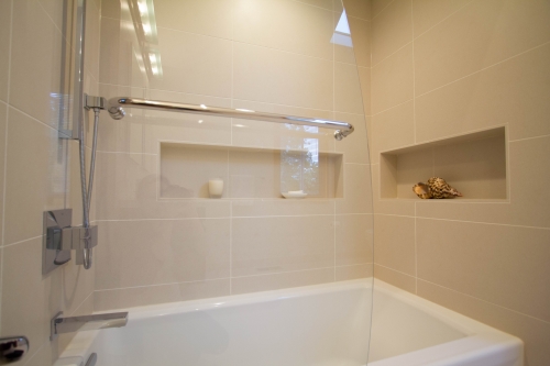 master bath remodel large format tile beige glass panel recessed niche