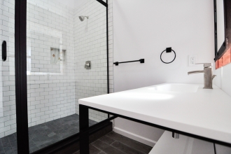 Modern Industrial Bathroom with Organic Elements in Center City 