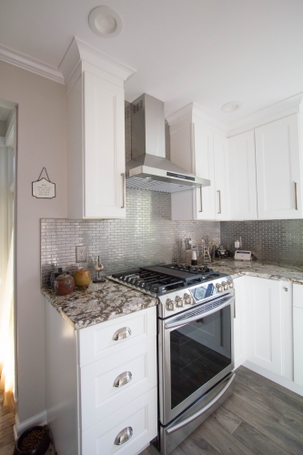 white kitchen gas range stainless hood