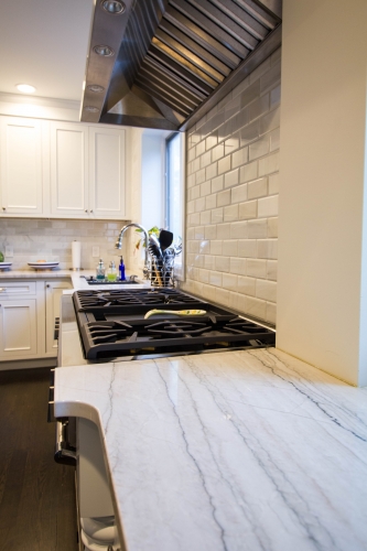 white traditional kitchen remodel linear quartzite counters